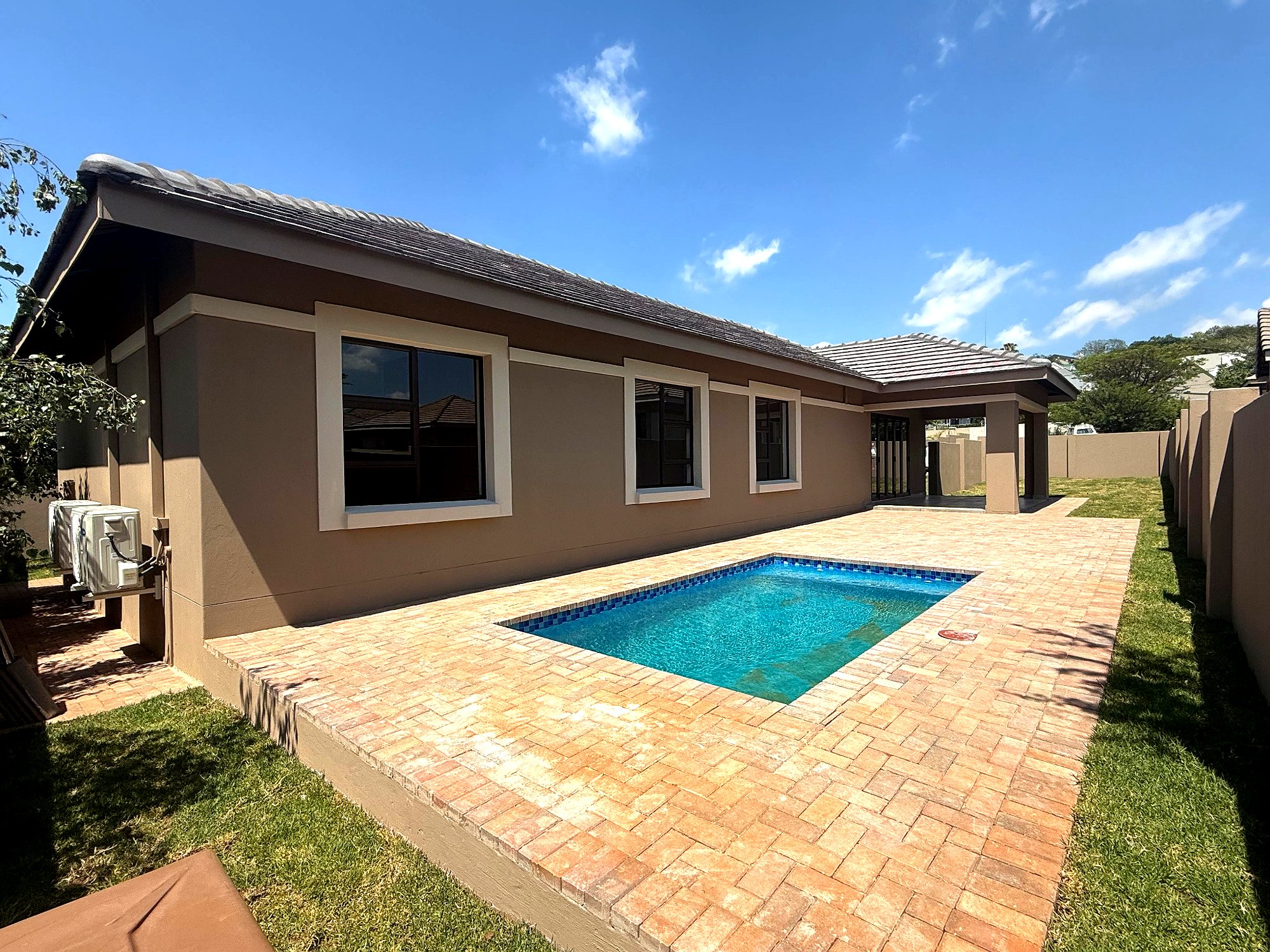 Project 1 rear courtyard with pool and completed brick paving