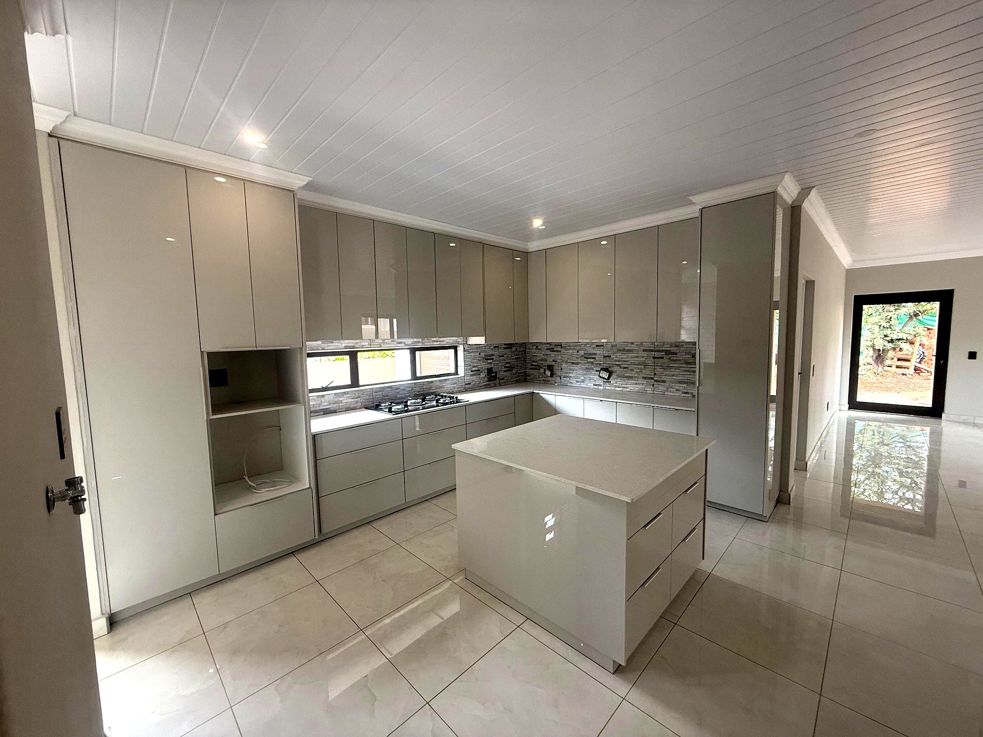 Project 1 kitchen with island and completed open-plan finishes